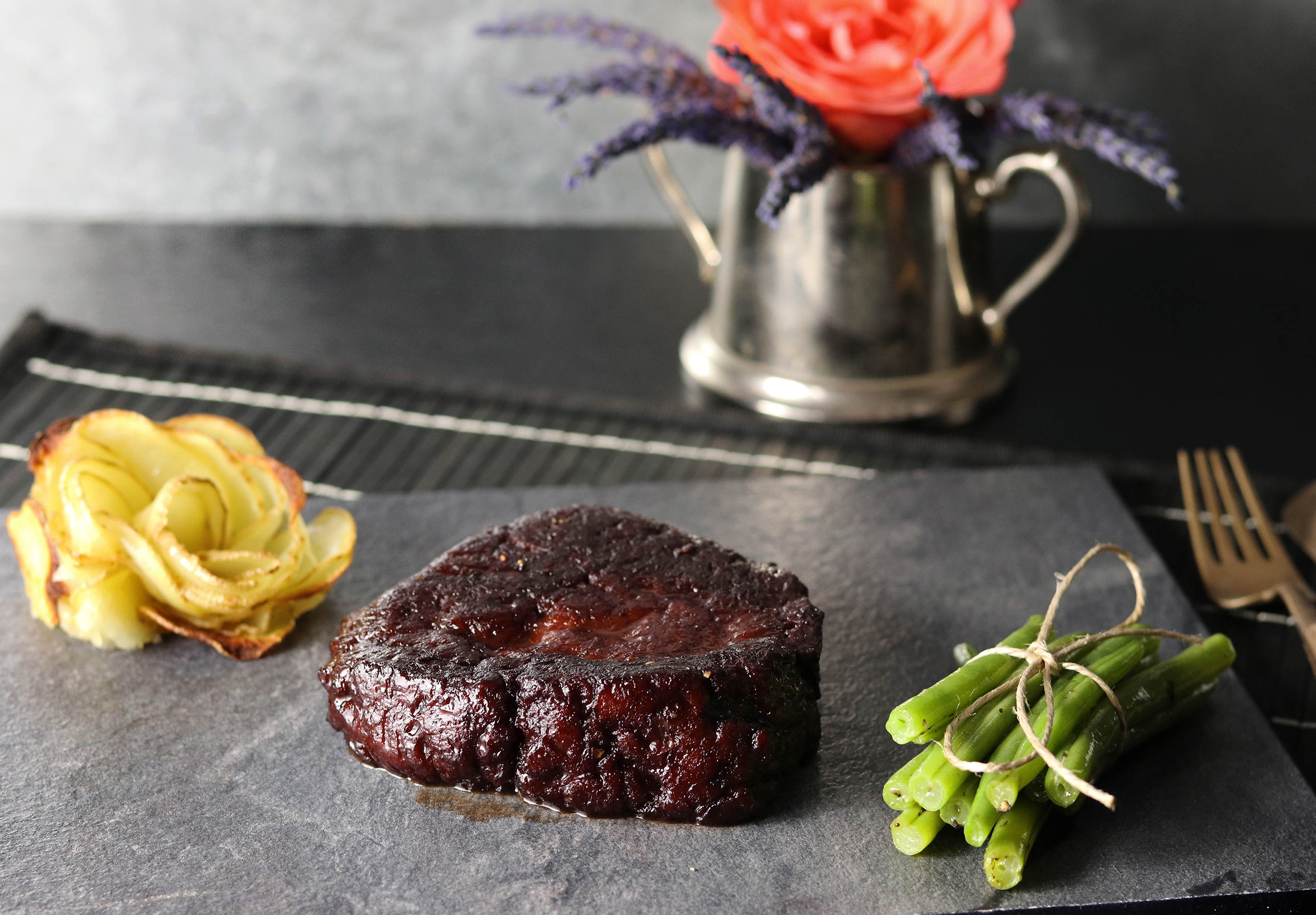 Seitan steaks in red wine glaze with potato roses and green beans