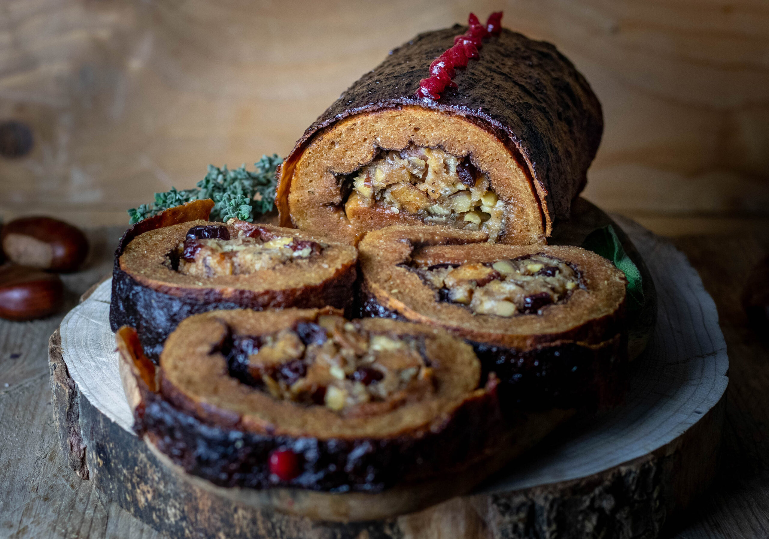 Festive stuffed roast with squeezed potatoes on shallot puree with berry and ginger caviar