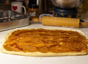 Covering the dough with pb and salted caramel sauce