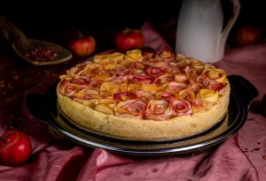 The apple cake is baked in a delicate, flaky shortcrust pastry