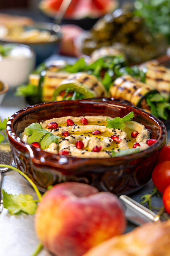 Baba Ganoush – Arabic eggplant dip - in a bowl on a table with different mezze