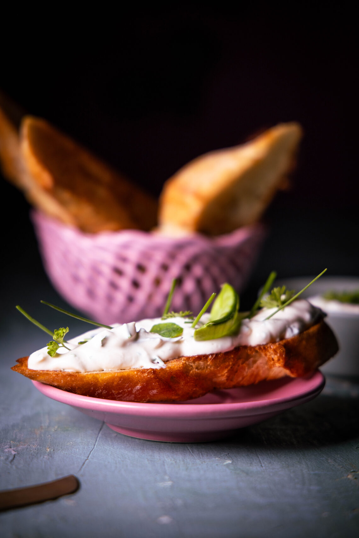 Vegan cream cheese with herbs on roasted bread.